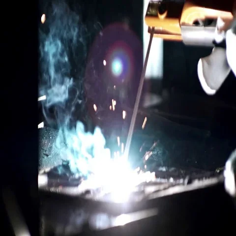 Welder worker welding metal by electrode at the factory Stock Footage 69609834
