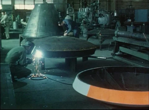A welder working on a boiler plate for testing during the Mercury Project Stock Footage 297465012