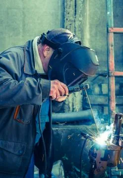 Welder working with electrode at arc werding Stock Photos
