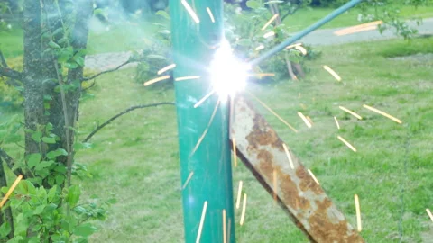 Welder working with electrode at semi-automatic arc welding metal pipes stand Stock Footage 154345129