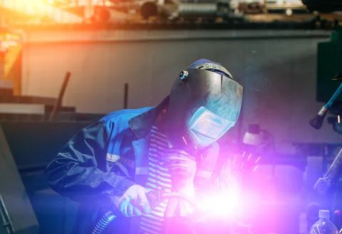 Welder working with electrode at semi-automatic arc welding. Stock Photos