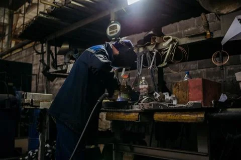 Welder working with electrode at semi-automatic arc welding. Stock Photos