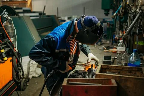 Welder working with electrode at semi-automatic arc welding. Stock Photos
