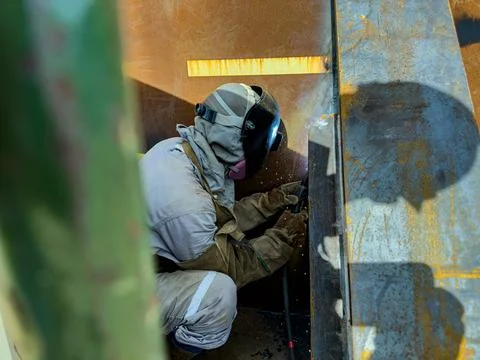 Welder working with an electrode. Welding work. Stock Photos