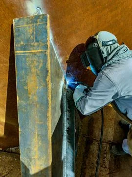 Welder working with an electrode. Welding work. Stock Photos