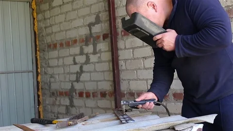 Welder Working in the garage Stock Footage 77581659
