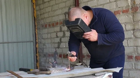 Welder Working in the garage Stock Footage 77581711