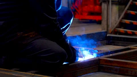 Welder working on metal beams in workshop. Stock Footage 341790027