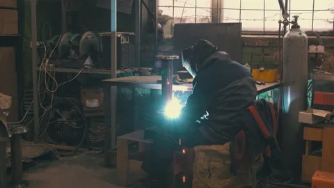 Welder Working in Metal Fabrication Workshop Wide Shot | Bright Welding Flash Stock Footage 343805751