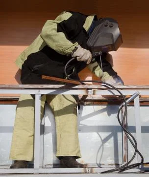 Welder working with a metal structure Stock Photos