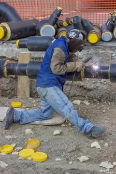 Welder working on pipeline construction Stock Photos