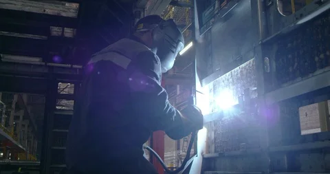 A welder is working at the plant Stock Footage 99316557