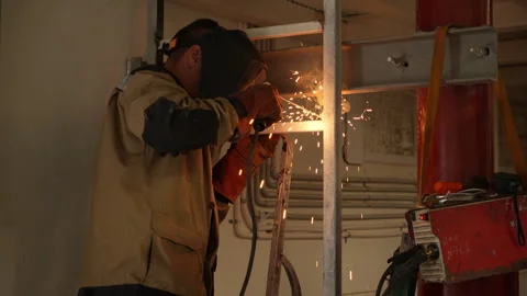 Welder working with protective mask and welding machine Stock Footage 315960307