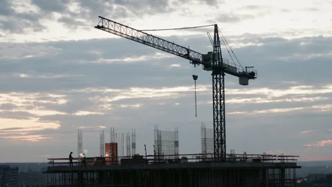 Welder working on skyscraper construction site at sunset Stock Footage 346047438