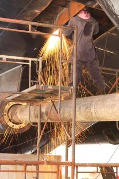 A welder working a torch at shipyard Stock Photos