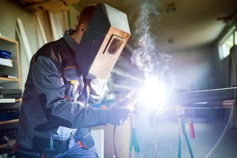 Welder working in workshop Stock Photos