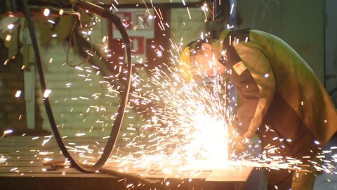 Welder works circular saw, cuts metal. Flies of spark from hot metal. In slow Stock Footage 92487635