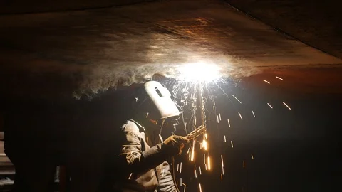 The welder works under the ship in dry dock Stock-Footage 87320722