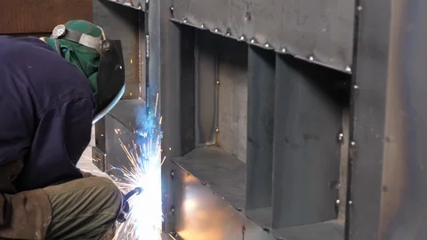 Welder works in a workshop, dolly shot, slow motion Stock Footage 93554574