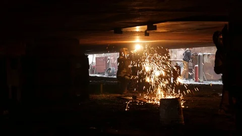 Welders under the ship in dry dock fly bright sparks Video stock 87320295