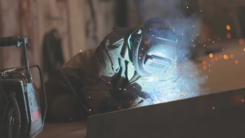 Welders weld large steel sections of a bridges box girder. Welders welding large Stock Footage 318419289