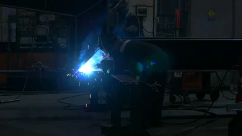 Welders weld large trailer frame at a factory. Stock Footage 197549131