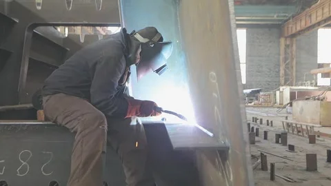 Welders welding large steel sections steel box girder of bridge. Welders weld Stock Footage 319194189