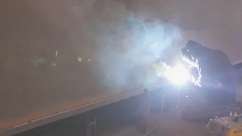 Welders welding large steel sections steel box girder of bridge. Welders weld Видео 320396860