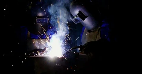 Welders welding a metal Stock Footage