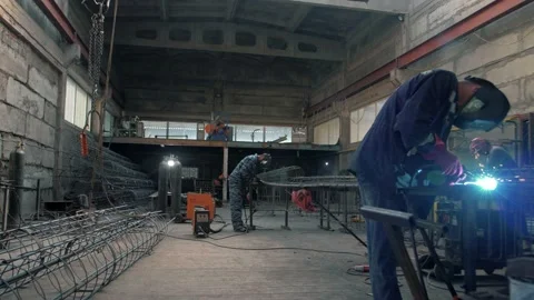 Welders work in a huge sheet-metal shop p Stock Footage 135315089