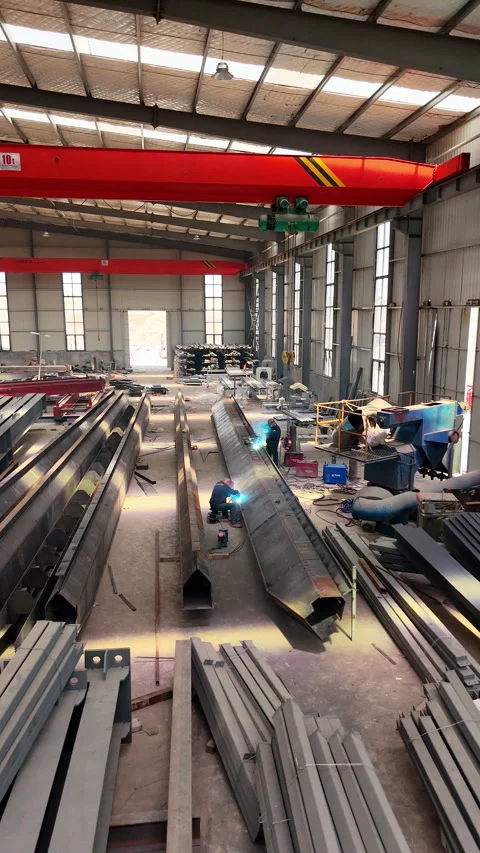 Welders Working on Structural Steel Beam Inside Factory Stock Footage 335793440