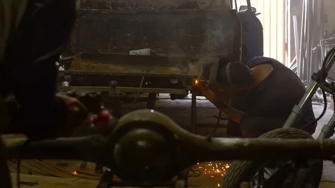 Welding and grinding work in a garage Stock Footage 80929298