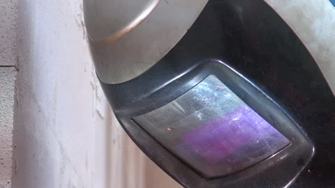 Welding and a welder doing his job in a protective suit Stock Footage 239768712