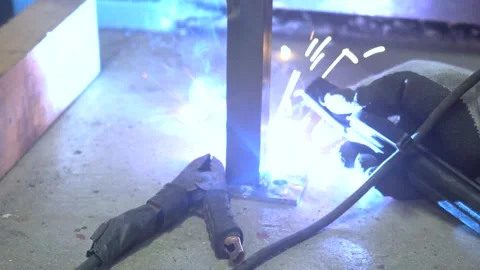 Welding a base with SMAW (Shielded Metal Arc Welding) or Stick Welding Stock Footage 302303125