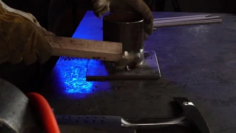 Welding Brush Removing Slag in a Workshop. Profile angle. Slow Motion Stock Footage 254744029