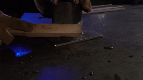Welding Brush Removing Slag in a Workshop. Profile angle. Slow Motion Stock Footage 254744885