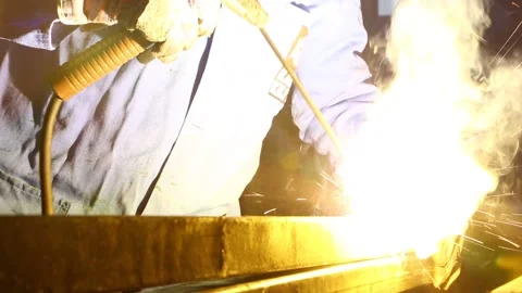 Welding close up shot against a dark background and sparks flying round Stock Footage 236706916