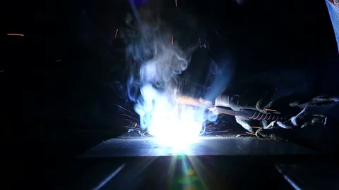 Welding close up shot against a dark background and sparks Stock Footage 236707026