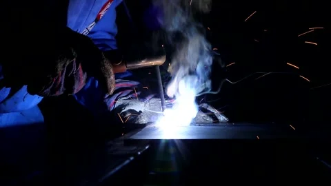 Welding close up shot against a dark background and a metal table Stock Footage 236707101