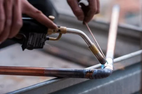 Welding of copper pipe. Stock Photos