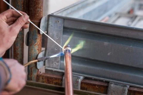 Welding of copper pipe. Stock Photos