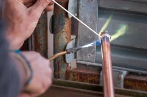 Welding of copper pipe. Stock Photos