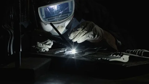 Welding in Dark Workshop Stockbeeldmateriaal 73716215