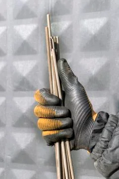 Welding electrodes in the hands of the worker Stock Photos
