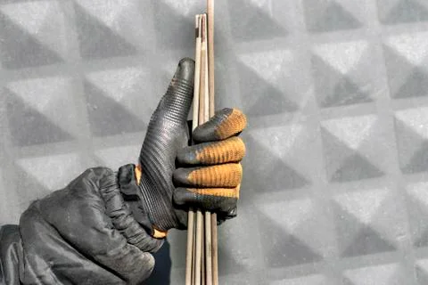 Welding electrodes in the hands of the worker Stock Photos