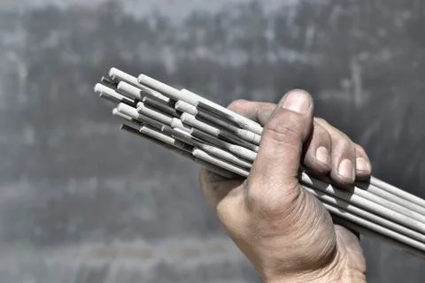 Welding electrodes in the hands of the worker Stock-Fotos