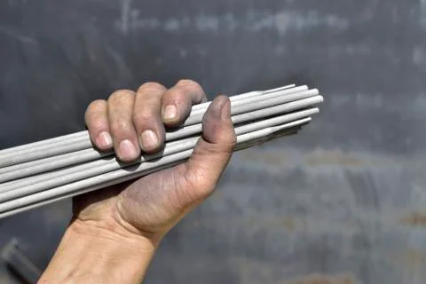 Welding electrodes in the hands of the worker Stock Photos