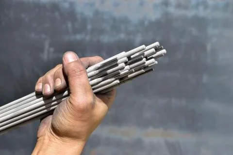Welding electrodes in the hands of the worker Stock Photos