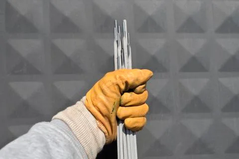 Welding electrodes in the hands of the worker Stock Photos