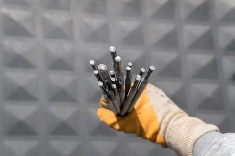 Welding electrodes in the hands of the worker Stock Photos